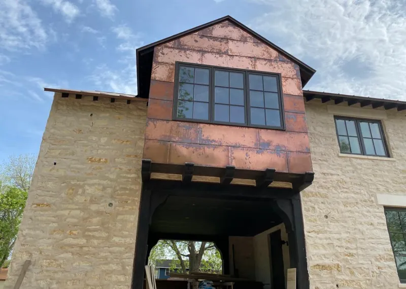 Copper metal panel facade on a stone building for Roof Repair in Sun City West